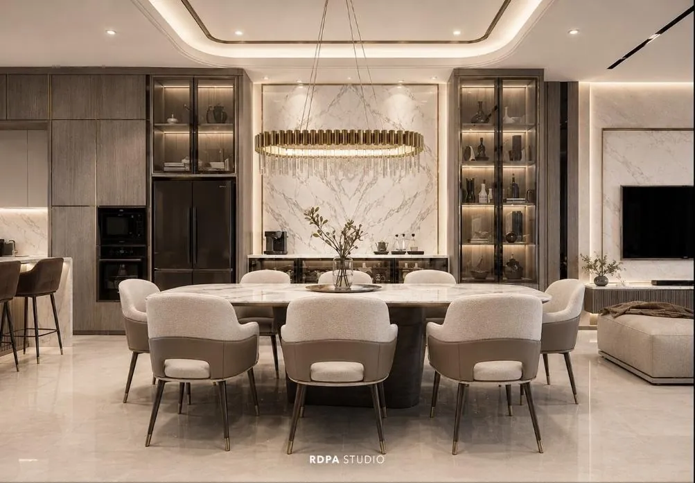 Dining room with a marble backdrop and a brass chandelier over an oval table
